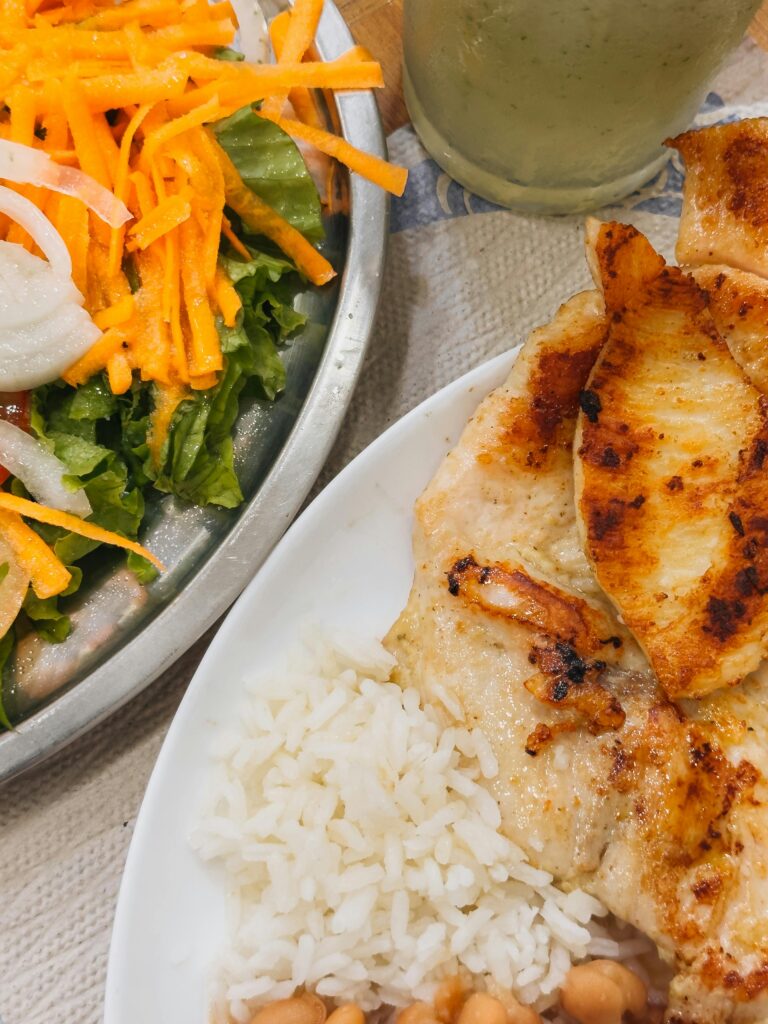 pexels-photo-34134207-34134207 Delicious grilled chicken with rice and fresh salad, perfect for a healthy meal.